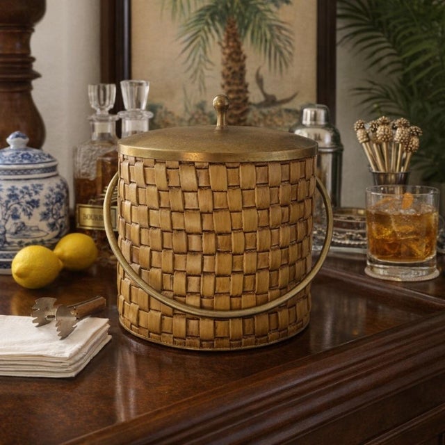 A beautifully preserved Mid Century Modern Thespis woven ice bucket, featuring the maker’s signature glass liner, brass...
