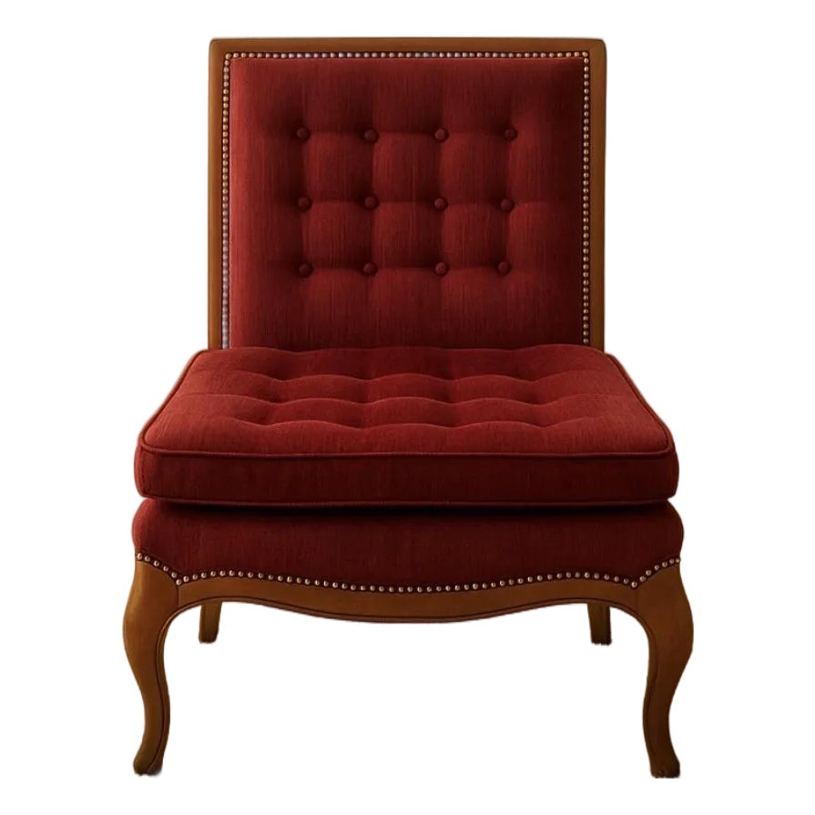 A vintage-inspired French chair upholstered in deep red velvet with wooden legs.