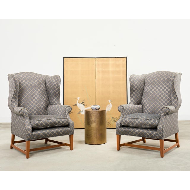 Handsome pair of bespoke midcentury wingback chairs crafted in the English Georgian taste. The chairs feature fully...