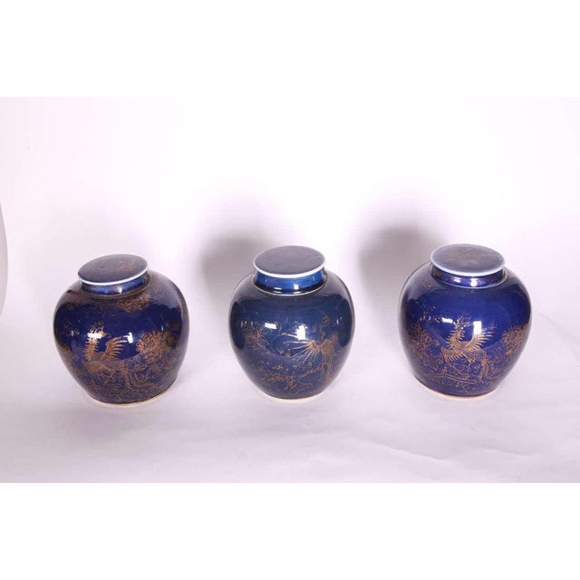 Three Chinese late 18th century Blue-Glazed and Gilt Porcelain Ginger Jars with a phoenix pierced on rock work, in a...