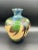 The Moorcroft Pottery Vase from 2010 is a 7" tall clay vase featuring a beautiful multicolor palm trees pattern,...