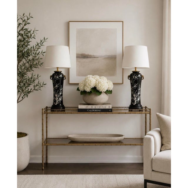 Very unusual black and white Chinoiserie design. These large lamps from the 1970s feature stunning black and white cherry...