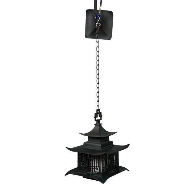 Circa 1960's black metal single light, hanging lantern / pendant light. Pagoda style lantern with a pierced chinoiserie...
