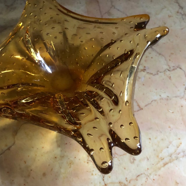 This is a striking irregularly shaped amber glass ashtray. It is in excellent condition and believed to be mid century...