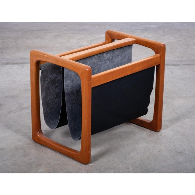 Elegant magazine holder designed by Danish designer Aksel Kjersgaard in the 1960s. Featuring a solid teak frame with dual...