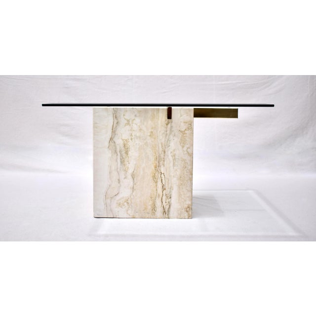Mid-Century Modern Artedi travertine coffee or cocktail table with brass support and beveled glass top. Distinct...
