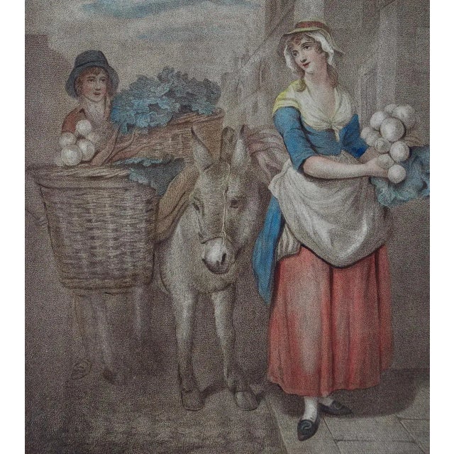 A beautifully framed hand-colored engraving from the famous "Cries of London" series, depicting the lives and professions...