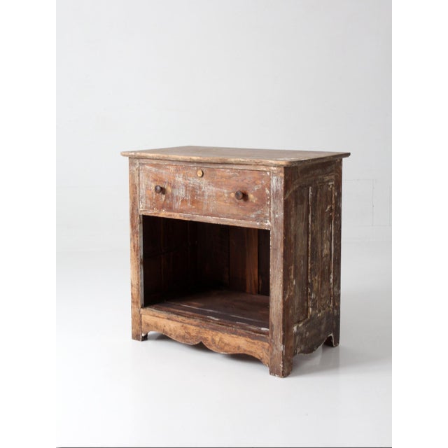 A 19th century cabinet with a single drawer over an open lower compartment, scaled in compact, easy proportions. Turned...