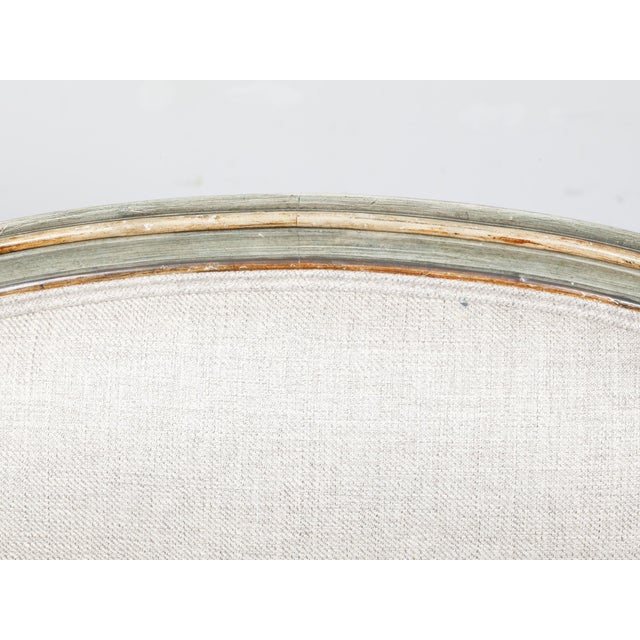 An Italian Rococo style settee from the 19th century with gray green painted finish, out-scrolling arms, shaped back and...