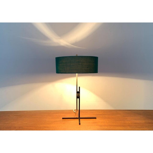 Very rare mid century table lamp by Kaiser glow with a special minimalist foot. The special detail of this lamp is the...