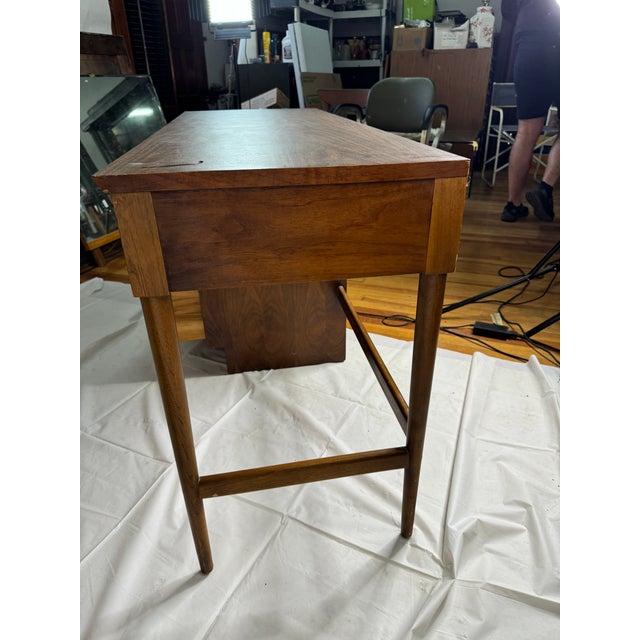 Beautiful vintage Lane walnut desk. The desk features atomic tapered legs, laminate top and large dovetail drawers with...