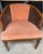 **Description:** Vintage barrel accent chair featuring elegant dusty rose upholstery, a woven cane back, and a gracefully...