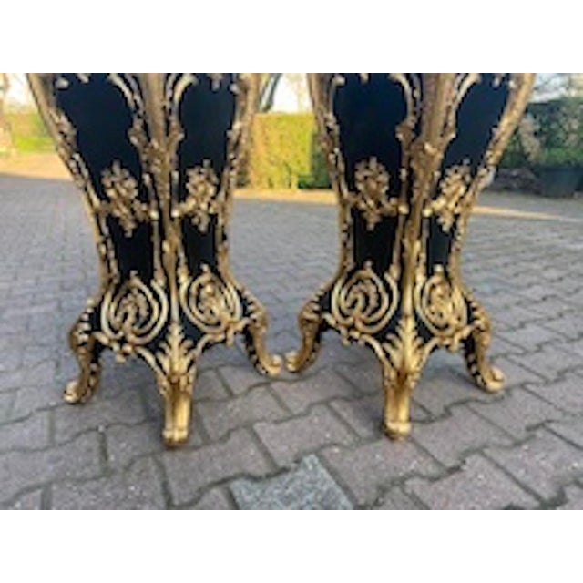 Pair of 1990 Italian Baroque Black and Gold Pedestals with Dark Marble-Effect Tops Infuse your space with the dramatic...