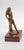 This graceful bronze figurine captures a serene, intimate moment as the figure holds a towel with both hands behind her...