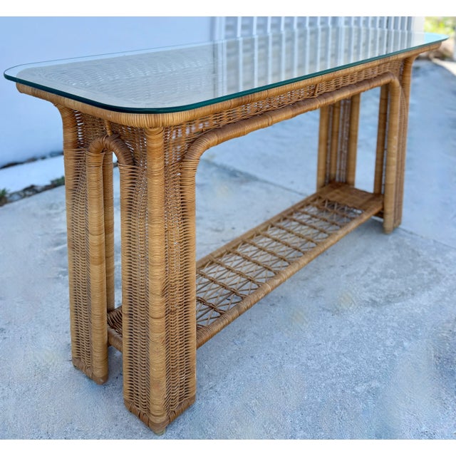 This is a vintage coastal organic modern rattan wrapped console table. Rattan and glass console tables are a type of...