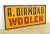 Reclaimed movie set sign made of aluminum in yellow, red, and black colors. The sign reads "A. Diamond Woolen". This was...