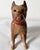 A vintage cast iron boxer dog bank. He’s wonderfully painted with a red collar.