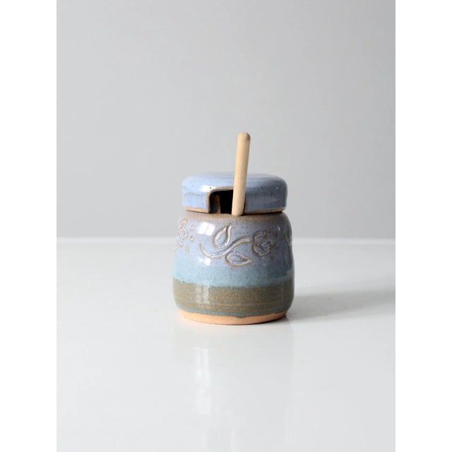 A vintage 1994 Crisman studio pottery honey jar, hand-crafted in ceramic and dated on the base. The jar features a soft...