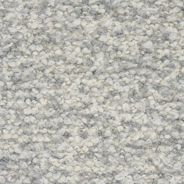 Extra-long loops of twisted yarn create a boucle with a classic m√©lange effect and an enveloping, fleecy softness. Sold...