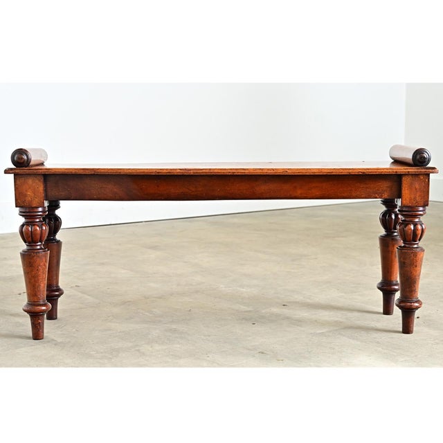 This 19th century hall bench, or window seat, from England shows impeccable quality within the natural characteristics of...