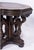 A richly sculptural Jacobean Revival oak center table, dating to the early 20th century, featuring a bold architectural...