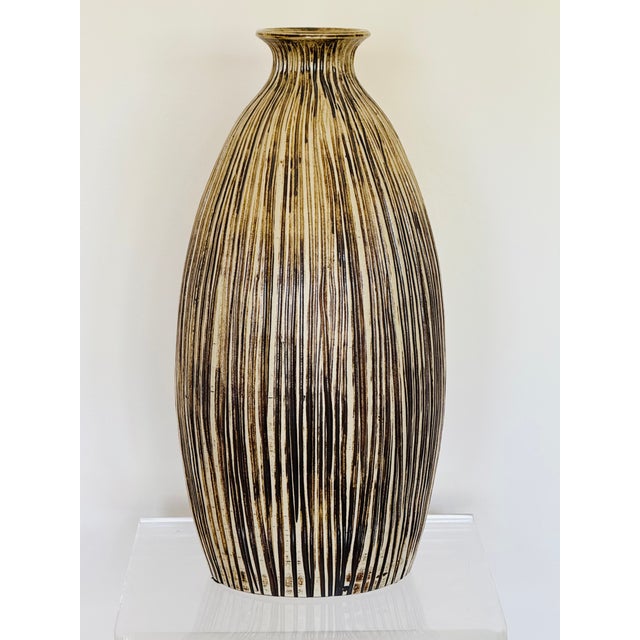 A large pottery vase with incised decoration. Impressed maker’s mark. Japanese studio ware circa 1960.
