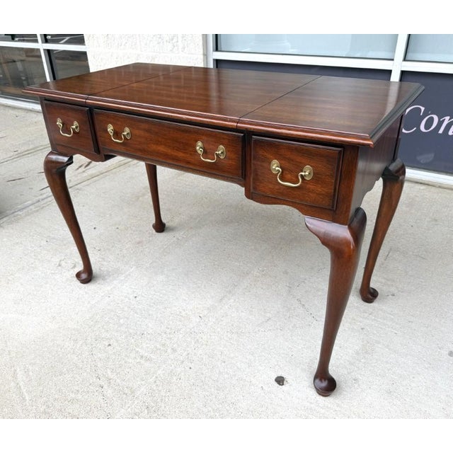 This Henkel Harris Solid Mahogany Vanity, Model No. 2704 and finish no. 29, features a graceful Queen Anne-inspired form...