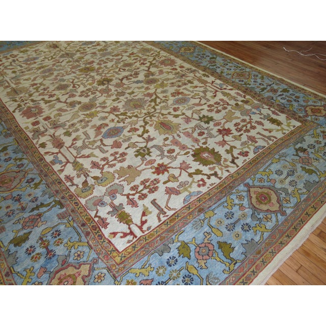 Vibrant Persian Mahal carpet, ivory field, and sky blue border with accents of green. Early 20th Century 10'9'' x 16'5''