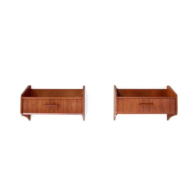 Beautiful set of two Danish design wall cabinets, manufactured by Uldum Møbelfabrik in the 1960s. These elegant bedside...