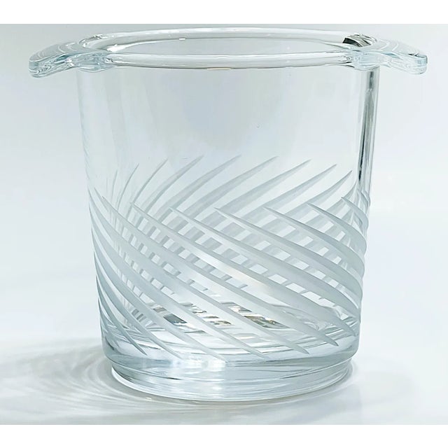 This is a small crystal ice bucket with etched, frosted, diagonal stripes that resemble palm fronds. It is an interesting...