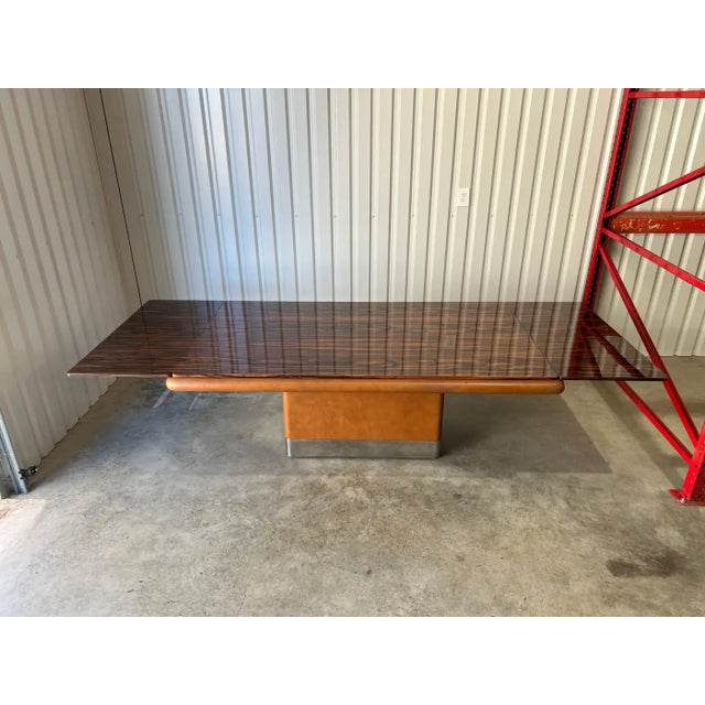 An exceptional and highly refined extendable dining table by Vladimir Kagan, featuring a spectacularly figured rosewood...