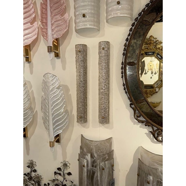 This listing is for a pair of elegant Murano glass tube sconces, featuring a textured design for added visual interest....