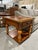 A classic Thomasville side table featuring a square top with burl wood veneer framed in solid wood. The design includes a...
