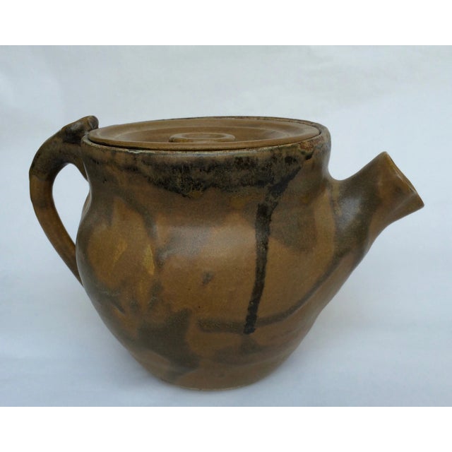 Hand thrown ceramic teapot with drip glaze and chunky lid. Matte brown colors. Artist signature on bottom.