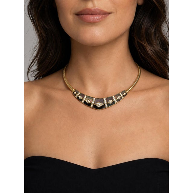 This stunning signed Gem Lok necklace is a powerhouse statement piece from the 1980s, crafted in luxurious 18K yellow gold...