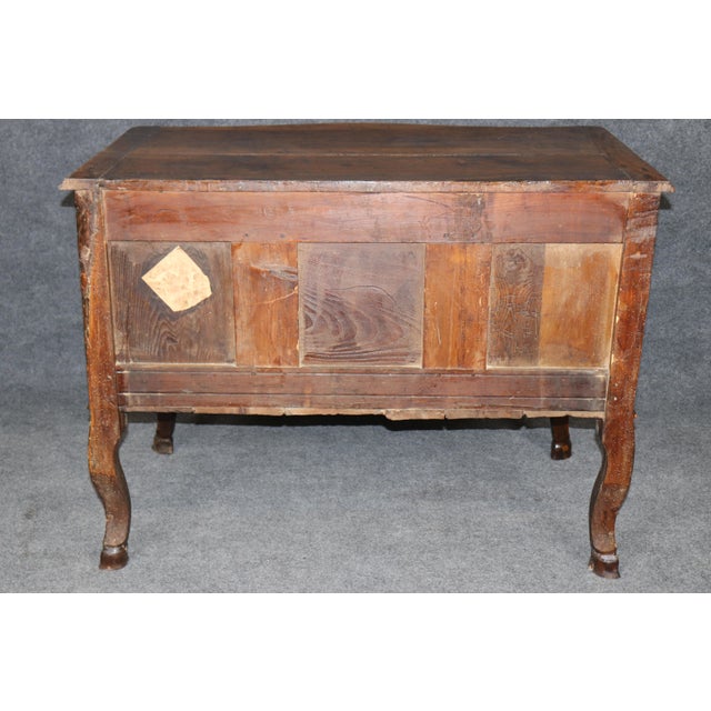This exceptional period French Louis XV walnut commode, crafted during the 1780s, represents the graceful refinement and...