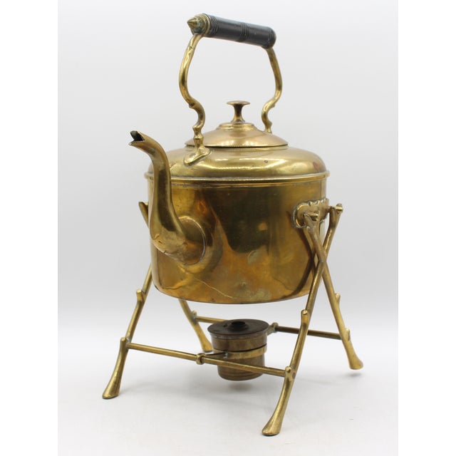Circa 1900 brass tea kettle on stand, English. Edwardian period. Faux twig heating stand. Turned wooden handle with...