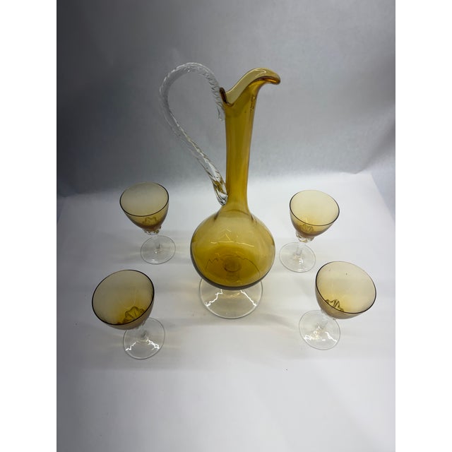 An elegant 5-piece vintage liqueur/wine set crafted in vibrant honey-amber hand-blown art glass. The footed pitcher...