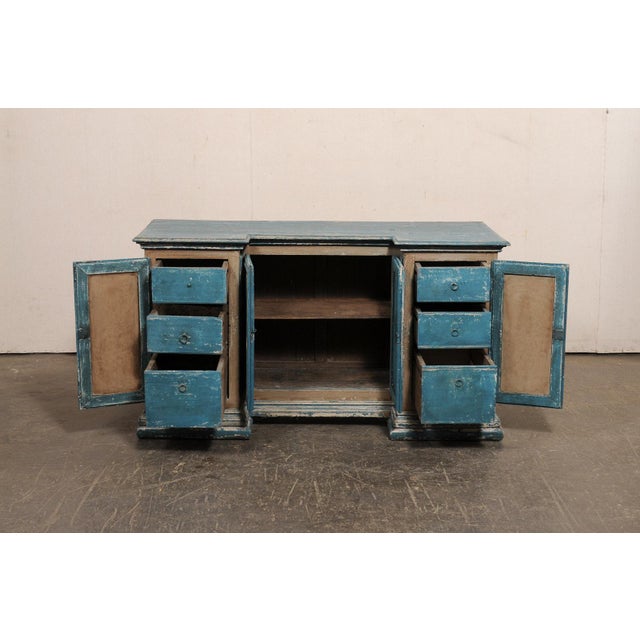 An Italian painted wood console cabinet, with unique reverse breakfront design, from the 19th century. This antique buffet...