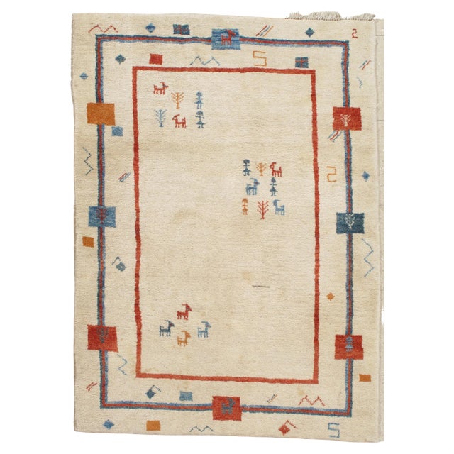 A whimsical vintage Persian Gabbeh rug with an natural creamy ivory/white background and a beautiful open design boarder....