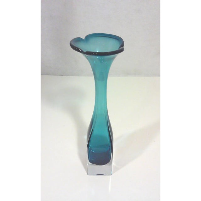 Scandinavian blue art glass vase with a flared mouth and squared base. 4ʺW × 4ʺD × 12ʺH