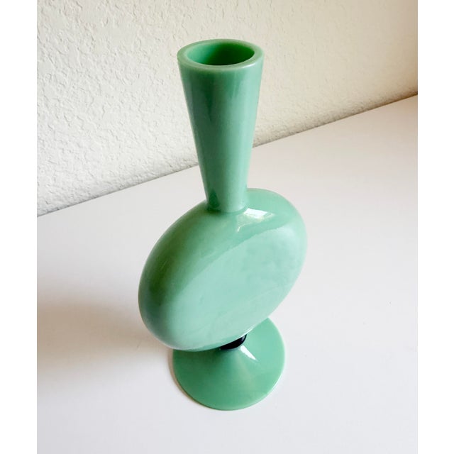 Stunning Art Deco vase in a vibrant mint green blown glass. Features graceful curves and a black ball accent at the base....