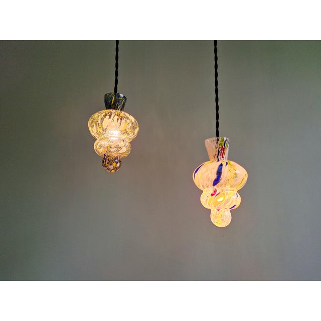 Magnificent pair of multicolored blown Murano glass pendant lights, 1950s-60s. Each pendant light has been restored and is...