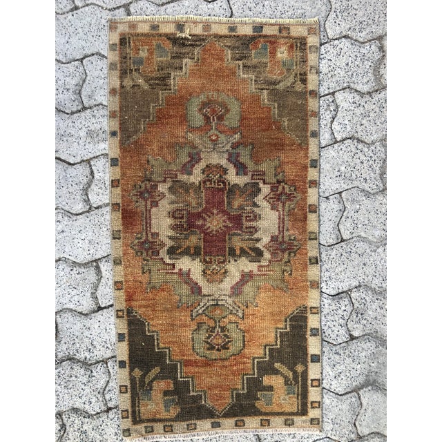 This is a vintage Turkish Oushak rug from the 1960s. The piece was hand-knotted.