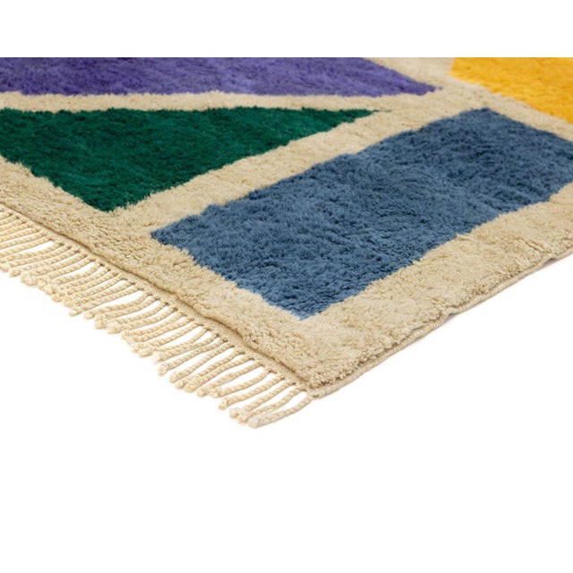 A kaleidoscope of color, inspired by the art of mosaic tilework. This hand-knotted Moroccan rug reimagines traditional...