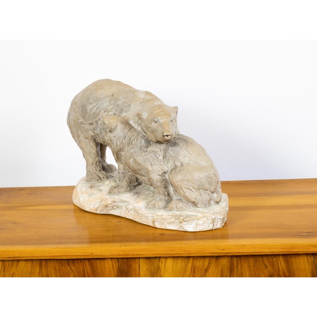 A Continental terracotta sculpture from the mid 20th century, depicting two bears on a base. Created during the midcentury...
