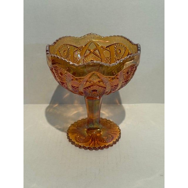 The Imperial Marigold Carnival Glass Compote in the “Octagon" Pattern is an antique piece made in America. This round bowl...
