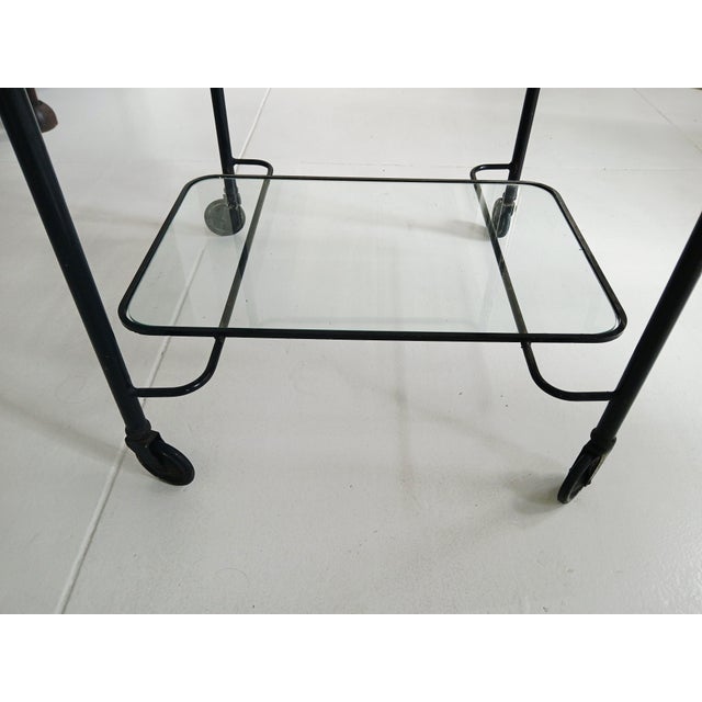A Mathieu Matégot Rolling Bar Cart. France, circa 1955-1956. Painted metal. Wave-pleated top apron in perforated metal,...