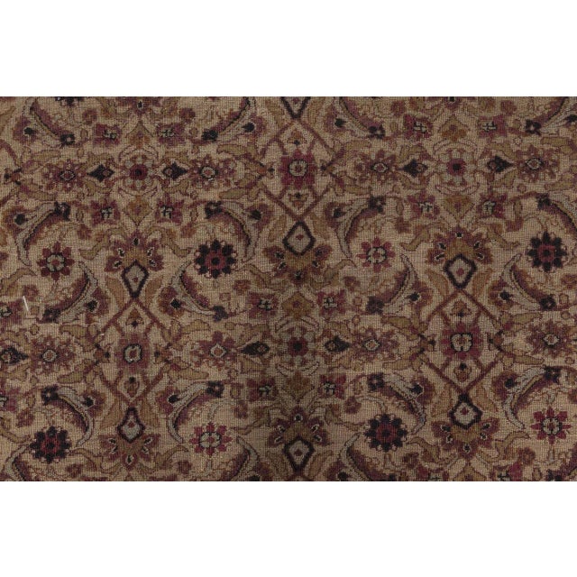 Radiating classical elegance and remarkable craftsmanship, this oversized antique Persian Meshad rugwoven circa 1900is a...