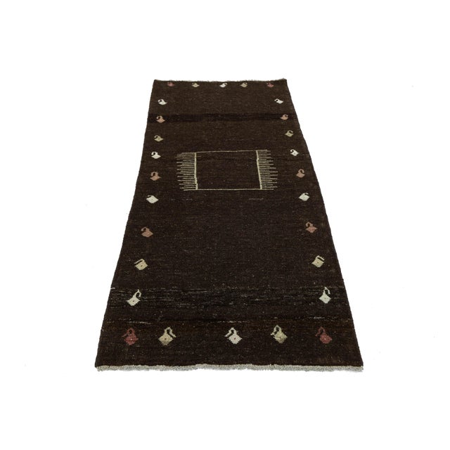 Add warmth to your home with this hand-knotted Gabbeh wool rug. Known for their thick pile and unique designs, Gabbeh rugs...